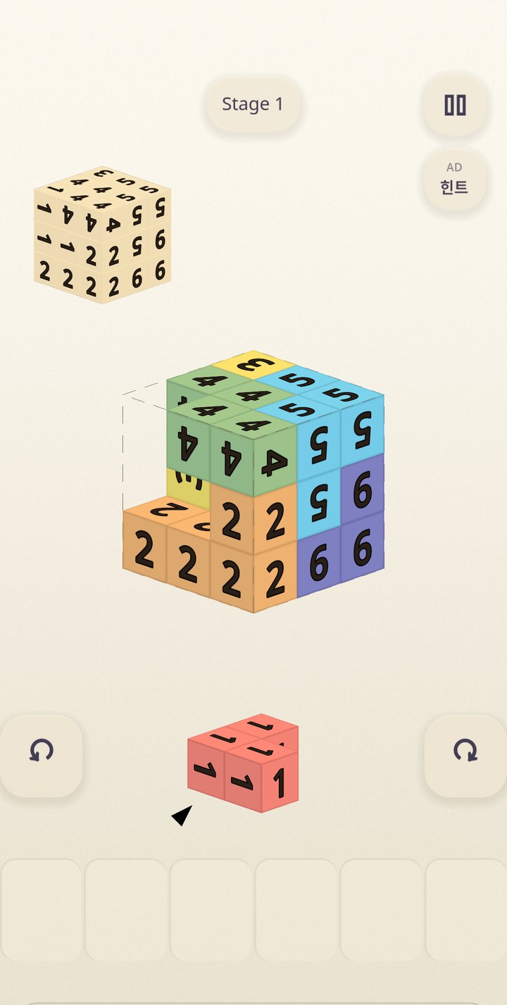 Gameplay: numbered matte pieces being fitted into a 3×3×3 cube, with a small blueprint cube above
